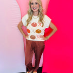 Cinnamon satin jogger-style pants with smocked elastic waistband, relaxed fit, and side pockets.