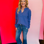 Marlin blue pullover top with V-neck, collar, and raw seam detailing.