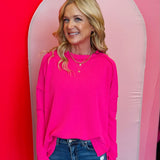 Hot Pink ribbed boat neck top with raw edge detailing, long sleeves, and relaxed fit.