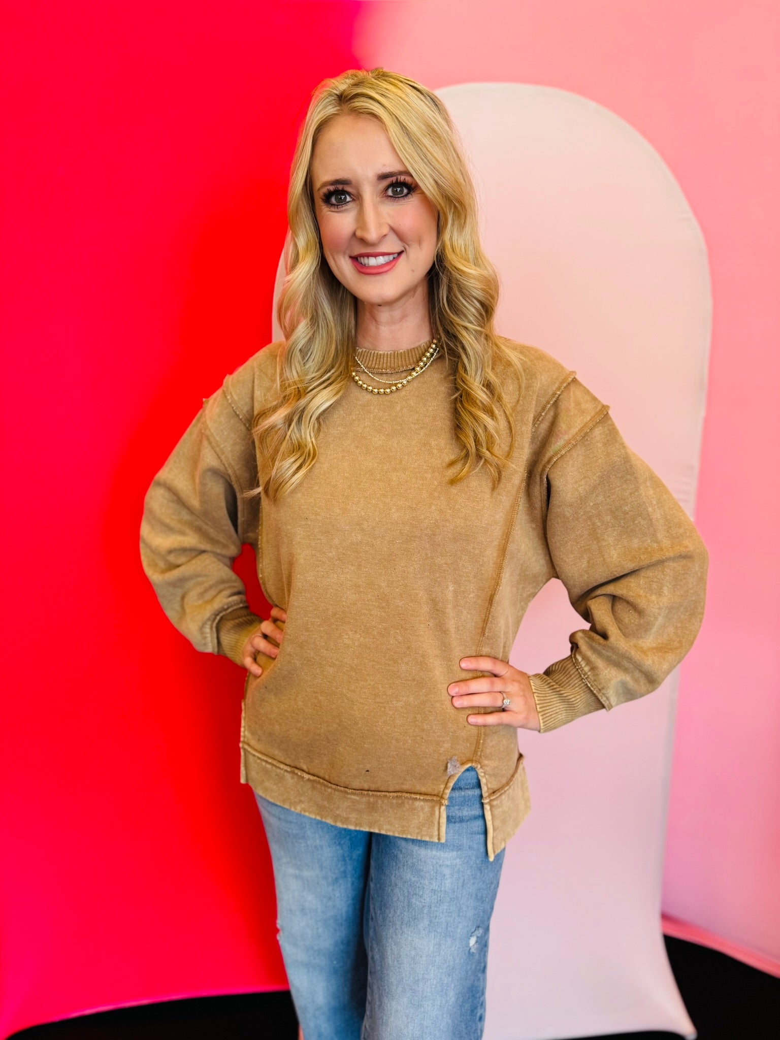Camel acid wash fleece sweatshirt with exposed seams, relaxed fit, and side slits.