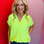 Lime green short sleeve Whitney top with v-neck and front pleat