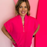 Hot pink half-zip high neck top with a soft, smooth finish, styled for a cozy yet trendy summer look.