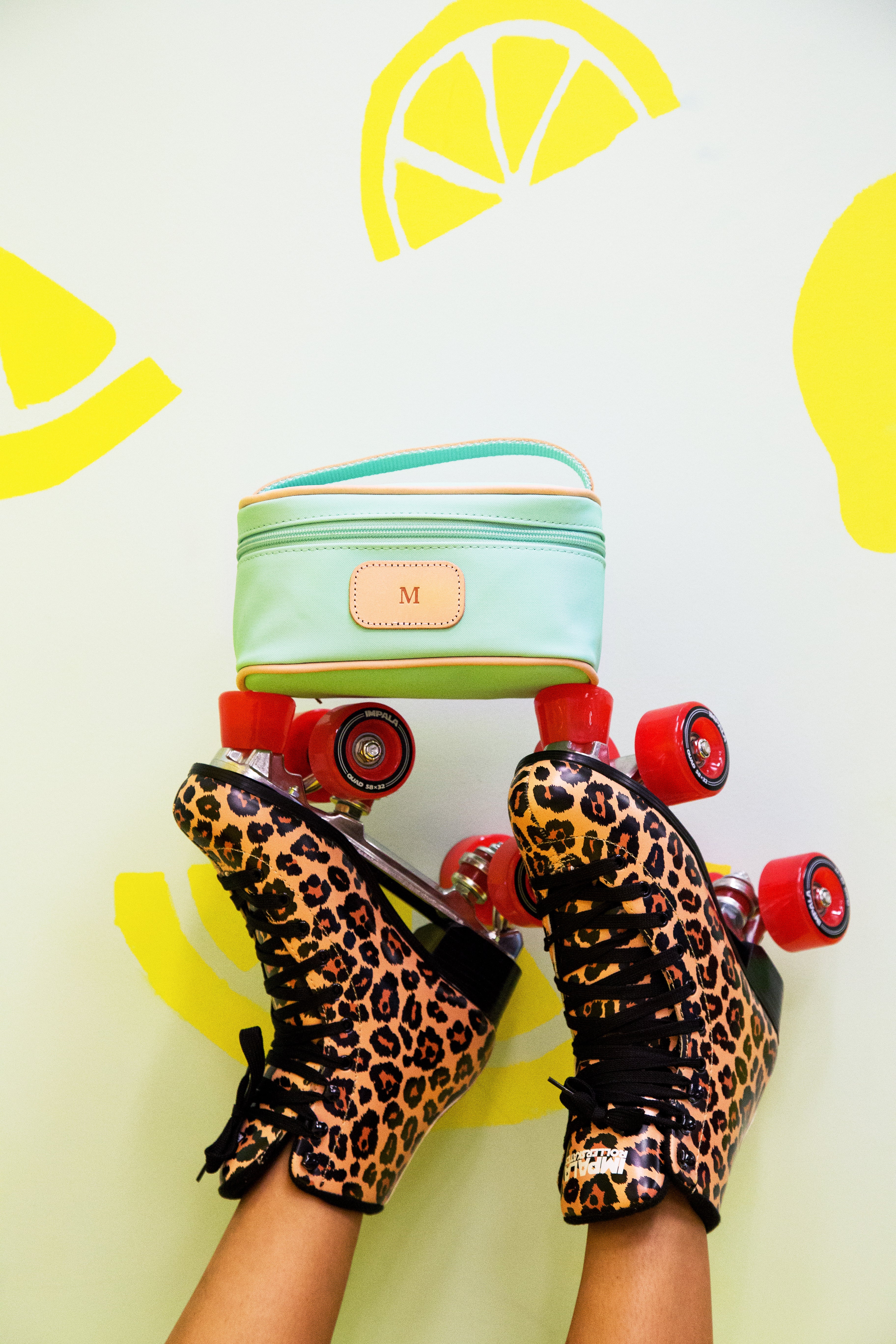 Jon Hart Mini Makeup Bag with coated canvas, leather trim, and zippered closure for stylish travel organization.