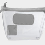 Jon Hart Airport Chico clear TSA-compliant travel pouch with steel Natural Leather trim, flat bottom, and zippered brass closure—perfect for carrying 3oz liquids and travel essentials.