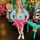 Mid-rise bow print shorts with tie waist drawstring, side pockets, and relaxed fit.