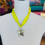 Lime green scarf necklace with a gold star charm, displayed on a neutral background. Lightweight and playful, this accessory adds a pop of color and whimsical shine to any outfit.