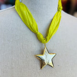 Lime green scarf necklace with a gold star charm, displayed on a neutral background. Lightweight and playful, this accessory adds a pop of color and whimsical shine to any outfit.