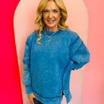 Ocean Blue acid wash fleece sweatshirt with exposed seams, relaxed fit, and side slits.