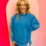 Ocean Blue acid wash fleece sweatshirt with exposed seams, relaxed fit, and side slits.