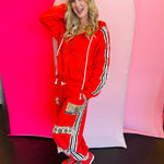 Red palazzo sweatpants with leopard print patches, studded side stripes, and relaxed fit.