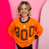 Orange sweatshirt with black neckline, cuff, and hem and 'BOO' and ghost design