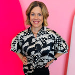A black and white tiger mix polka dot printed button-down shirt with half sleeves.