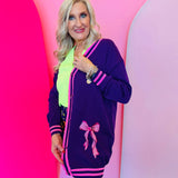 Purple cardigan with hot pink stripe trim and pink sequin bows