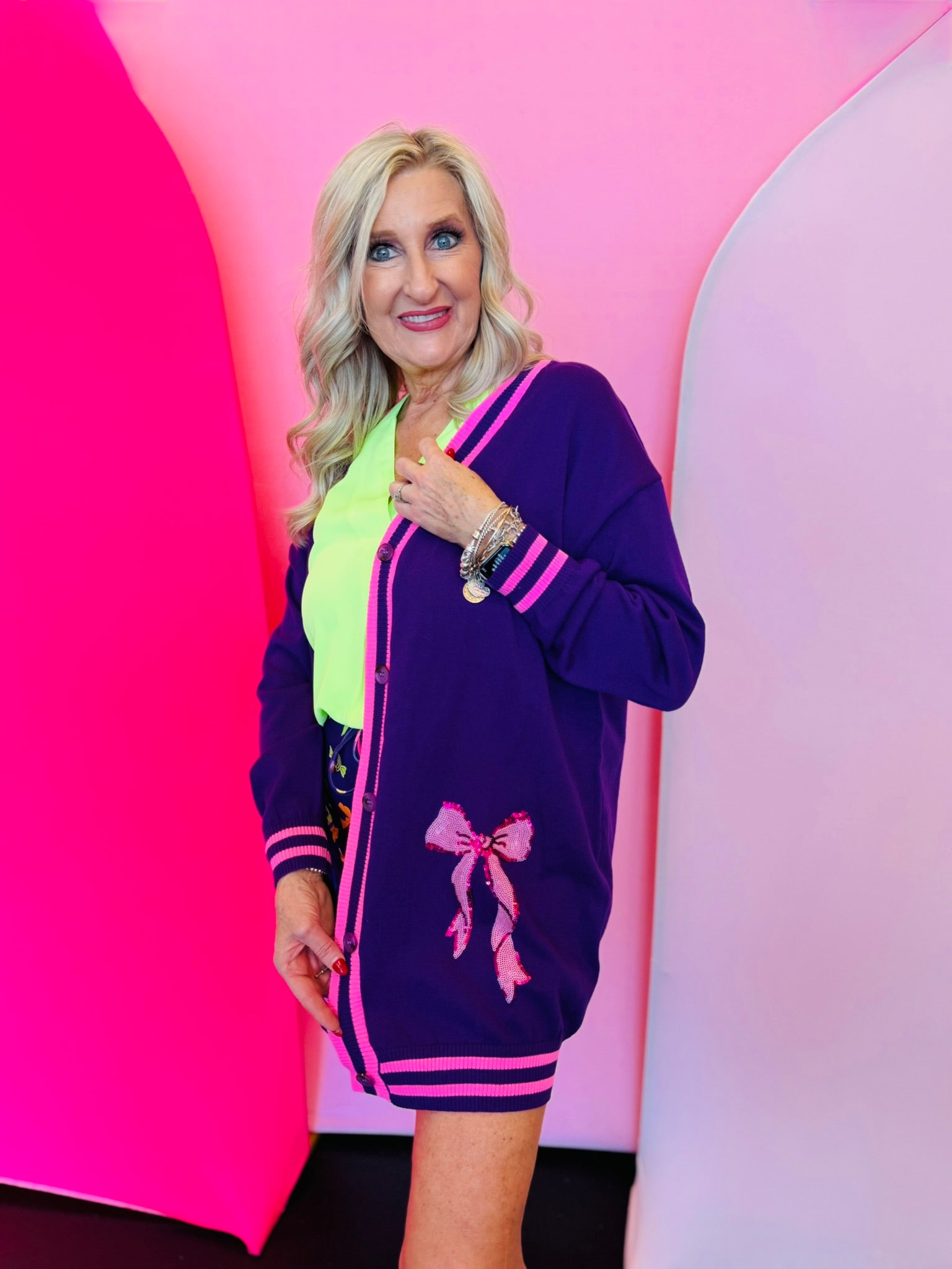 Purple cardigan with hot pink stripe trim and pink sequin bows