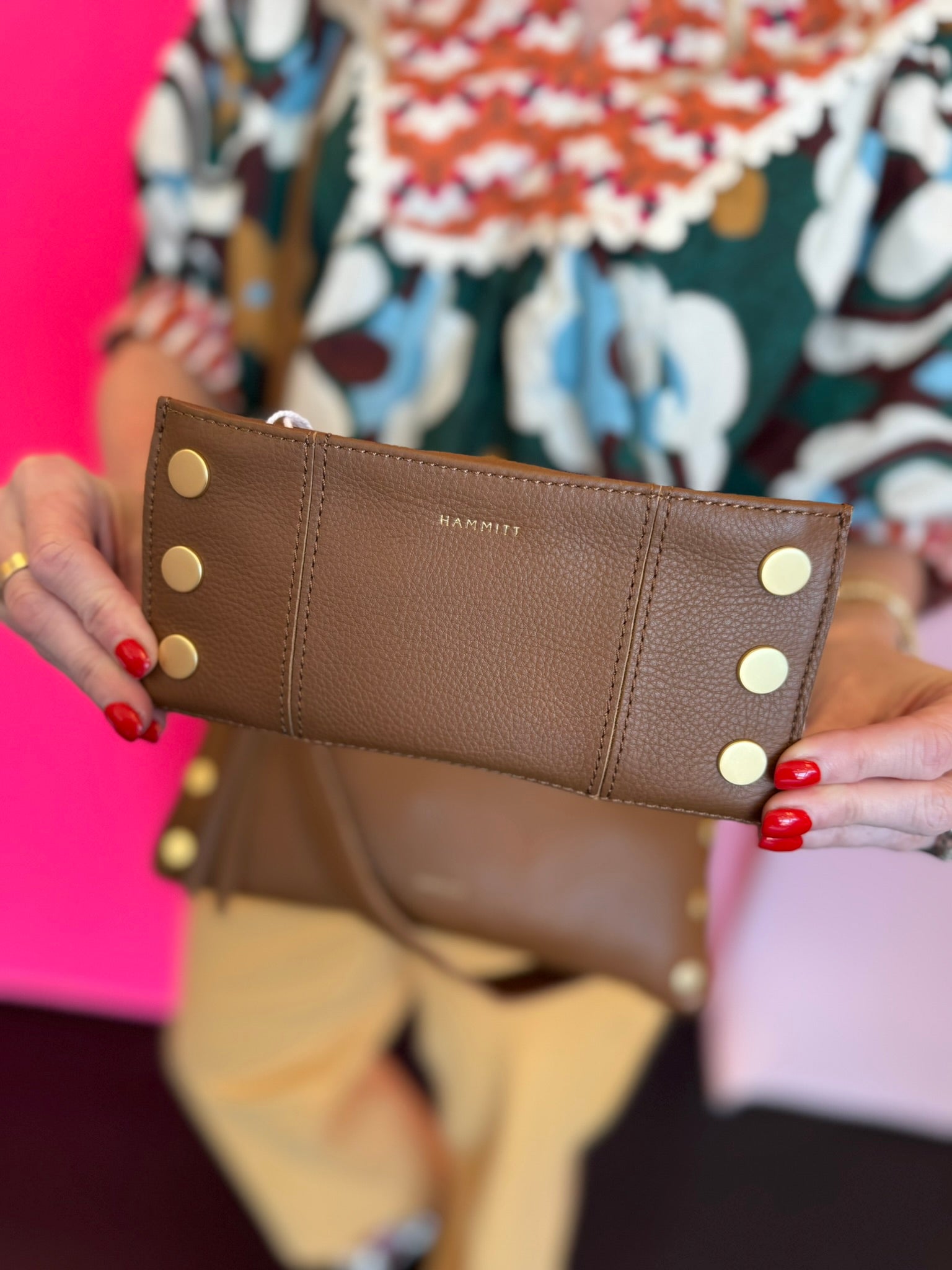 Hammitt 110 North mahogany luxury leather folding wallet with a magnetic closure, red accents and gold hardware.