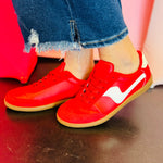 Red leather and suede sneakers with white accents and red laces.