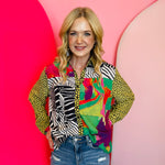Yellow abstract print blouse with collared neckline and button-down front.