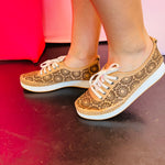 Tan leather sneakers with laser-cut design.