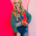 Emerald abstract print blouse with collared neckline and button-down front.