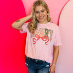 Pastel pink “Merry” sublimated Christmas tee with bow, reindeer and gingerbread men.