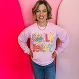 Pink Holly Jolly sweatshirt with rhinestone lettering, ornaments, and snowflake accents.