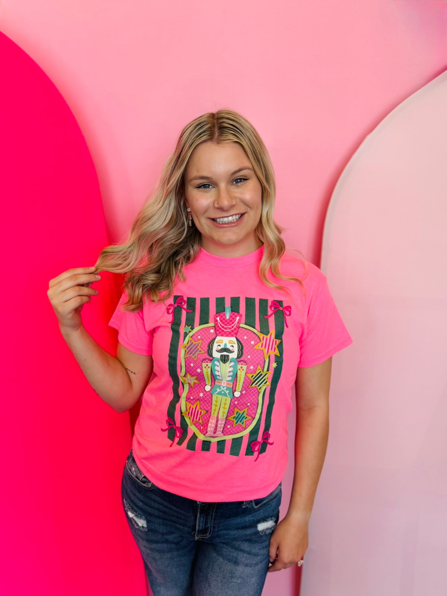 Nutcracker Tee in neon pink with cute nutcracker graphic, unisex fit, and soft 50/50 blend.