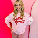 Pale pink sweatshirt with chenile Santa's Favorite lettering and sequin Santa down both sleeves.