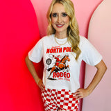 Santa rodeo graphic tee with “North Pole Rodeo” text on soft red cotton.