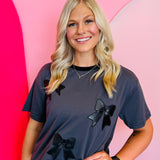 Oversized tee with faux leather bow, embroidered detailing, and contrasting collar.