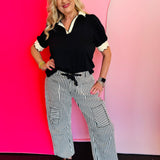 Black twill striped barrel-leg pants with subtle vertical stripes, featuring a natural rope twine belt threaded through eyelet loops; styled for a flattering, modern fit with a breathable 100% cotton fabric.