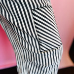 Stitched Pocket on Black twill striped barrel-leg pants with subtle vertical stripes