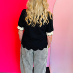 Black twill striped barrel-leg pants with subtle vertical stripes, featuring a natural rope twine belt threaded through eyelet loops; styled for a flattering, modern fit with a breathable 100% cotton fabric.