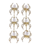 Dangling earrings with descending spiders with pearl bodies and crystal legs