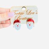 Santa earrings with glitter hat, pearl trim, and snowflake-detailed beard for festive holiday style.