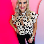 A button-front leopard print top with ruffle details on the sleeves.