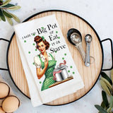White cotton tea towel with vintage housewife and octopus pot graphic, “Eat It or Starve” quote.