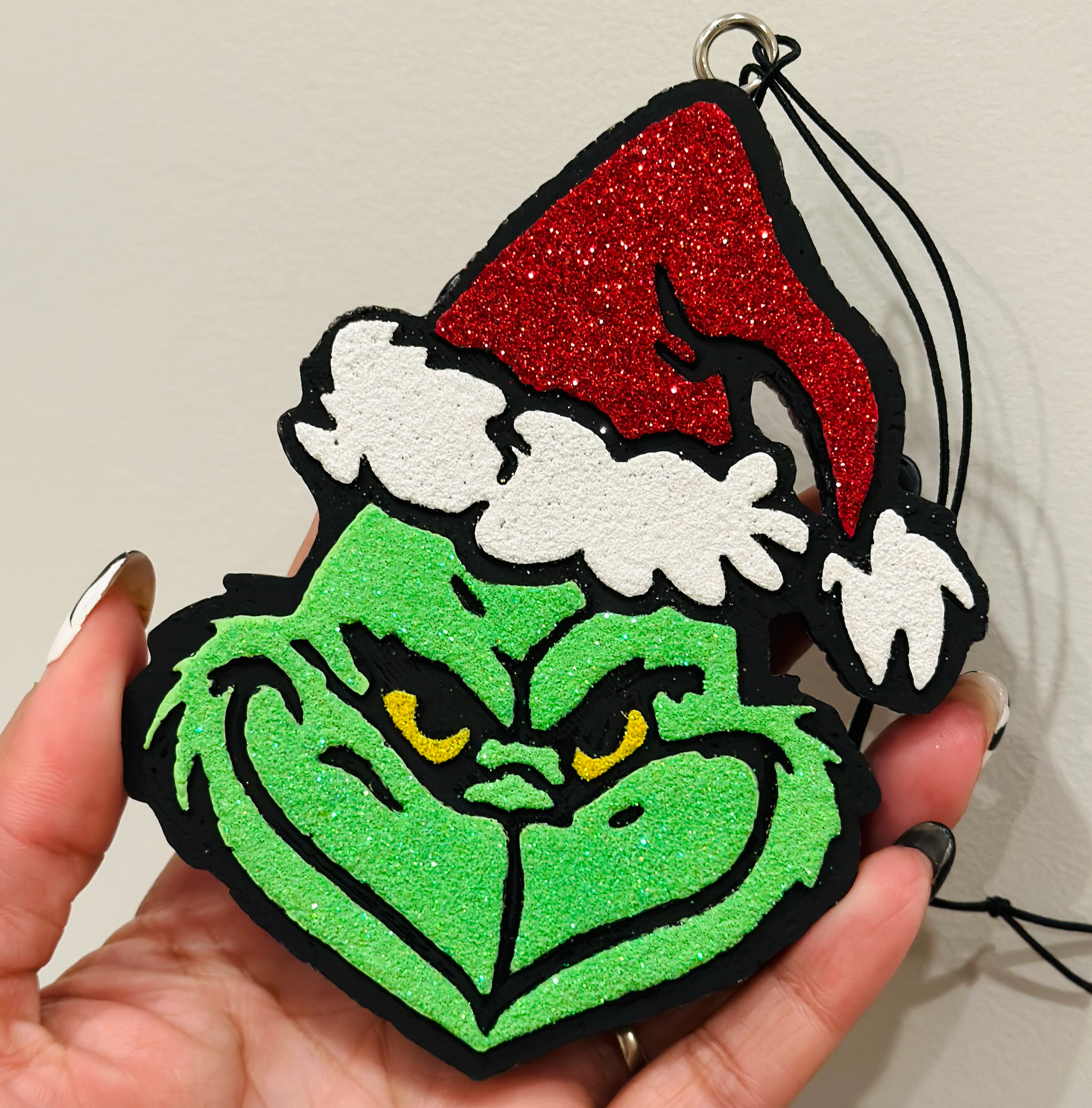 Grinch face car freshie with Santa hat and fruity Butt Naked scent for festive holiday fun.