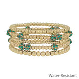 Five-piece gold and emerald pave ball stretch bracelet set with CCB beads.