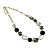 Aster Black Multi Crystal Necklace, 16–18 in gold chain with alternating black and clear faceted stones.