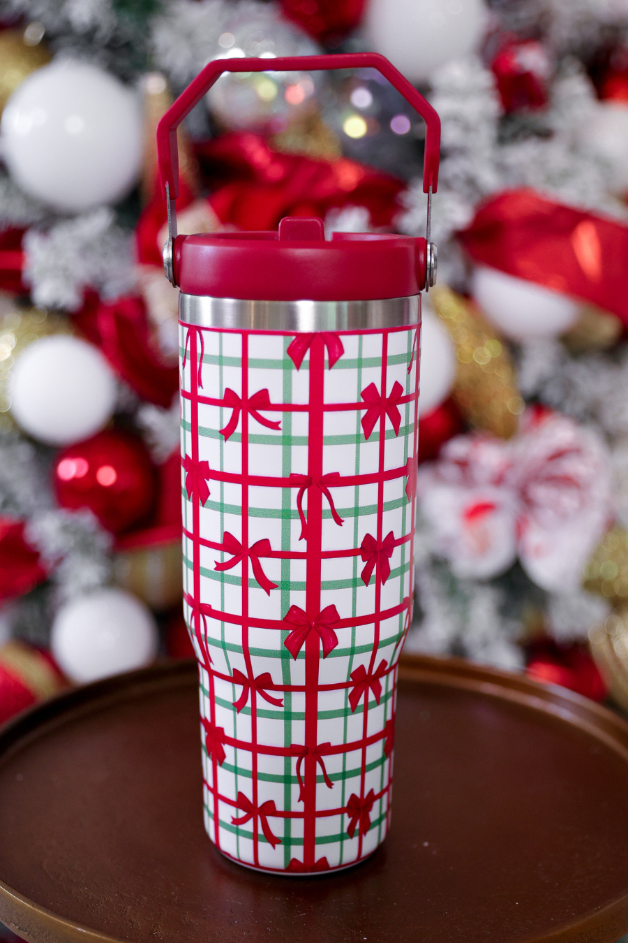 Plaid holiday tumbler with red bows, handle, and screw-on lid, 30oz size.