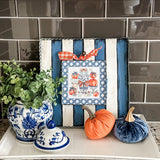 Blue pumpkin topiary with chinoiserie pots, bows, and lattice border on 12x12 fall metal board
