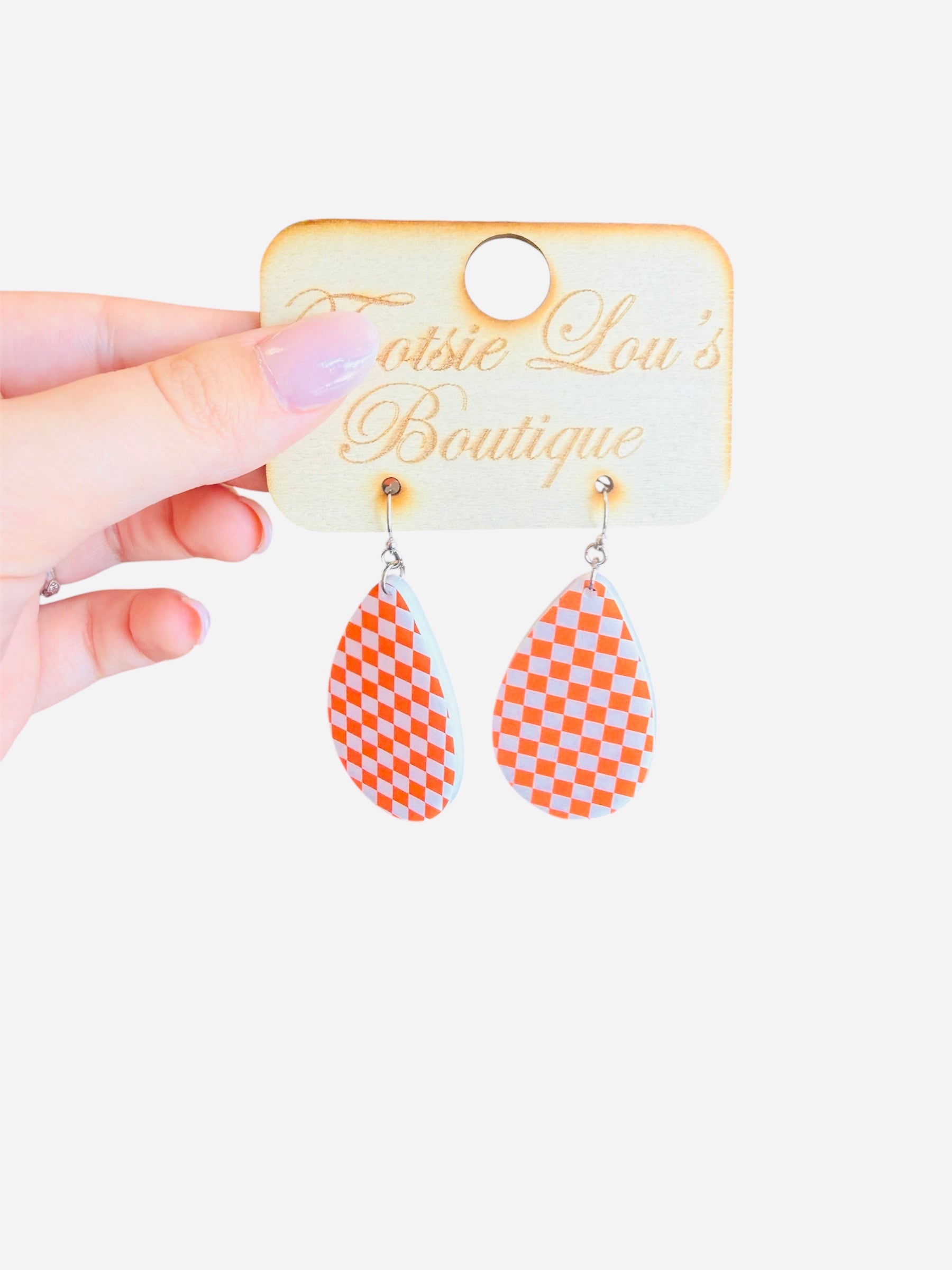 Orange and white checkered teardrop earrings in glossy acrylic, lightweight and perfect for bold style.