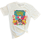 Flat lay of the Vaya Con Dios Tee on a plain surface, displaying the colorful floral print and rhinestone embellishments on the front.