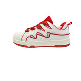 Red and white sneakers with a dynamic wave design, thick platform sole, and zigzag laces — bold, sporty, and eye-catching.