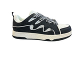 Black and white sneakers with a bold wave design, thick platform sole, and zigzag laces — modern, sporty, and edgy.