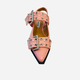 Pink pointed-toe flats with bold silver double buckle straps and a slingback backstrap, combining vibrant color with edgy charm.