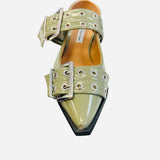 Olive pointed-toe flats with bold silver double buckle straps and a slingback backstrap, combining vibrant color with edgy charm.