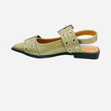 Olive pointed-toe flats with bold silver double buckle straps and a slingback backstrap, combining vibrant color with edgy charm.