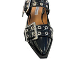 Black pointed-toe flats with bold silver double buckle straps and a slingback backstrap, combining vibrant color with edgy charm.