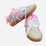 Brown and white sneakers with pink laces and a floral print design.